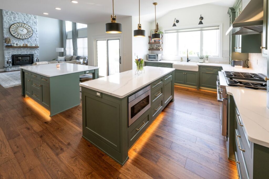 An elegant culinary space demonstrating affordable kitchen and bathroom remodeling, featuring beautifully crafted double kitchen islands with inset custom cabinet doors and integrated storage.
