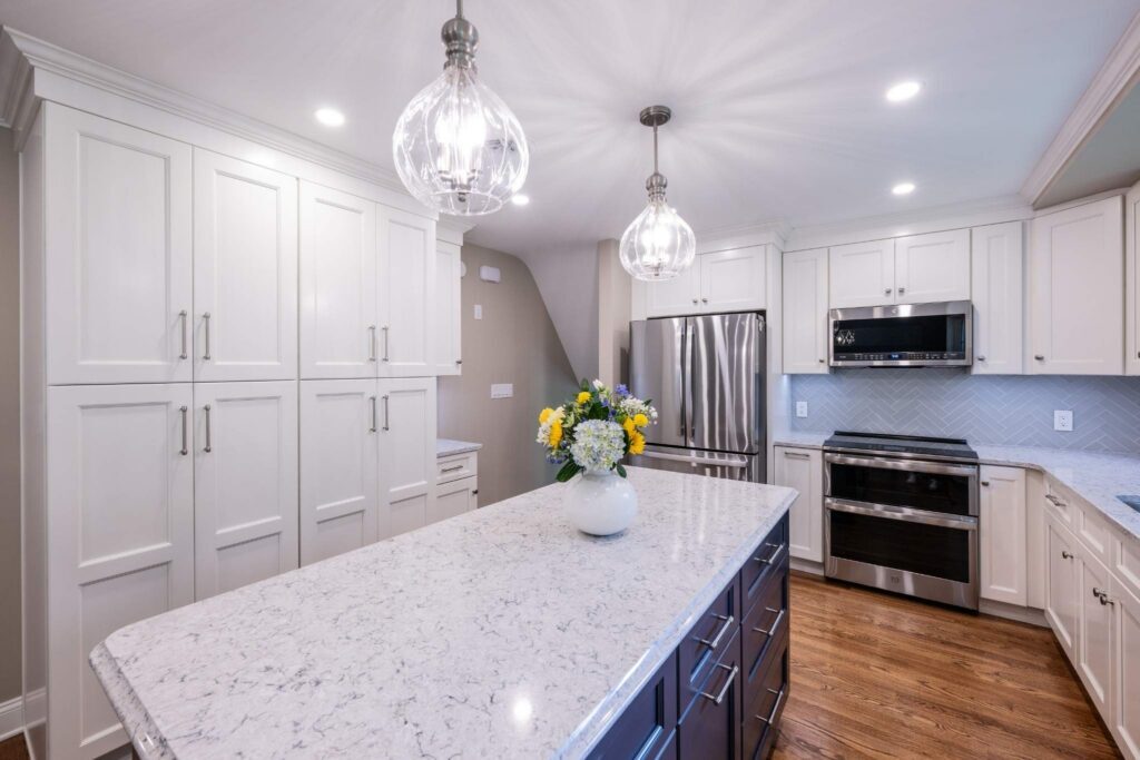 An elegant and highly functional space demonstrating how to choose a kitchen remodeler, featuring beautiful full-overlay custom cabinet doors and a sleek modern backsplash.