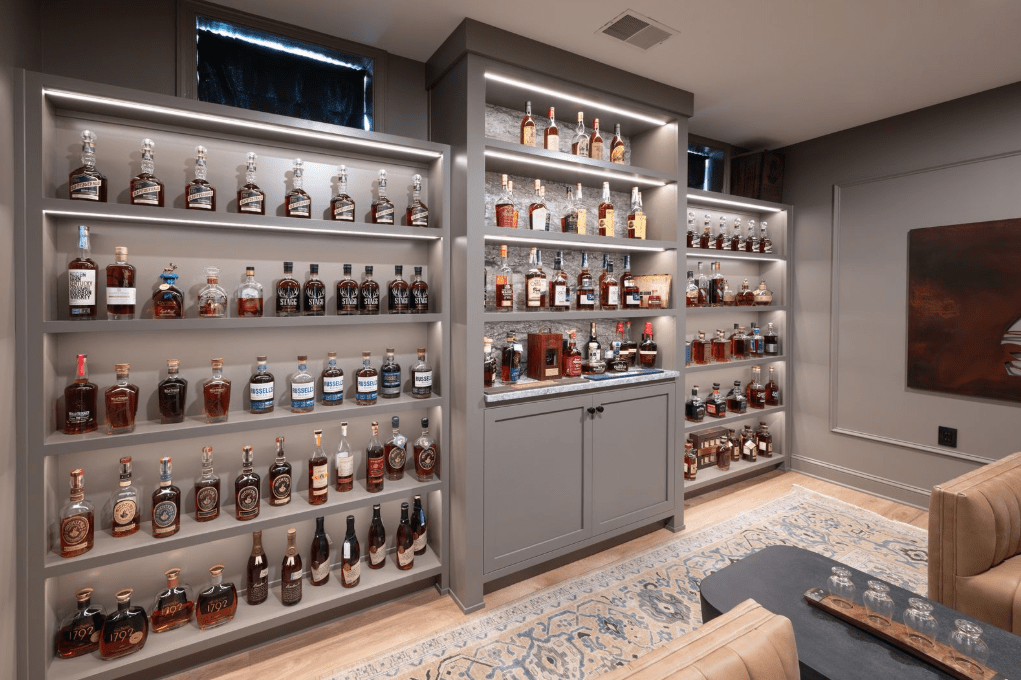 A view of the completed whiskey bar in Center Valley, PA featuring Blue Dunes granite countertops with custom millwork.