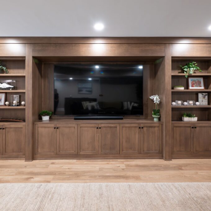 A view of the completed custom remodel in Center Valley, PA featuring a closed hard maple bookcase with hidden door and custom millwork.