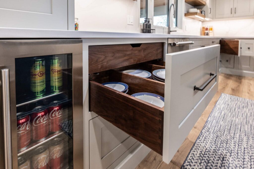 A beautiful transitional design created by trusted kitchen designers, highlighting stunning solid wood dovetail drawer boxes and rich hardwood flooring.