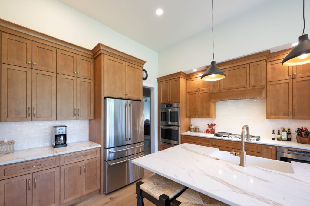 Open-concept kitchen layout in Bethlehem, PA, showcasing the custom painted center island topped with Michael Angelo Gold quartz.