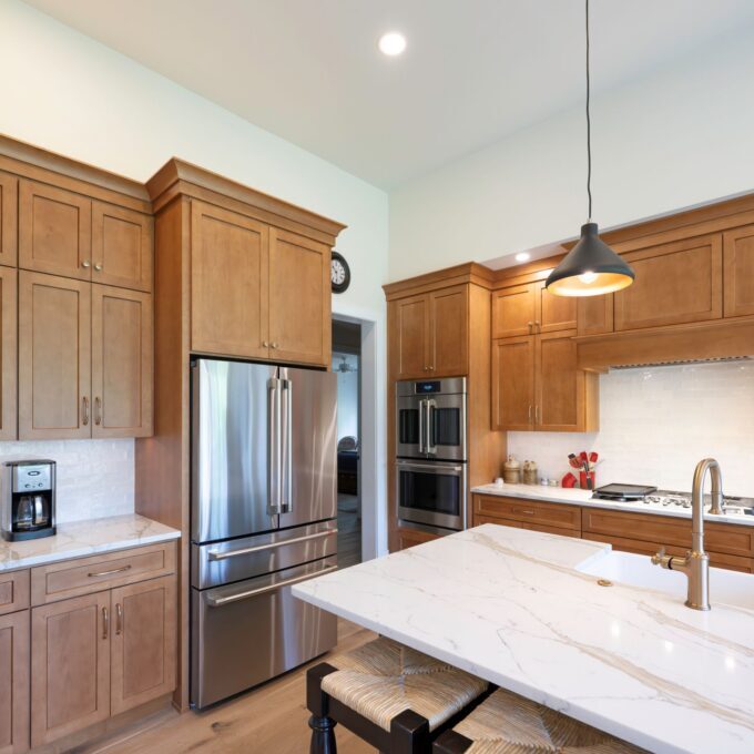 Open-concept kitchen layout in Bethlehem, PA, showcasing the custom painted center island topped with Michael Angelo Gold quartz.