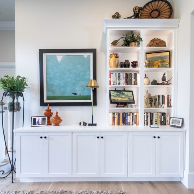 Bethlehem built-in bookcase with open shelves, concealed base cabinets, and space for framed artwork beside the staircase.