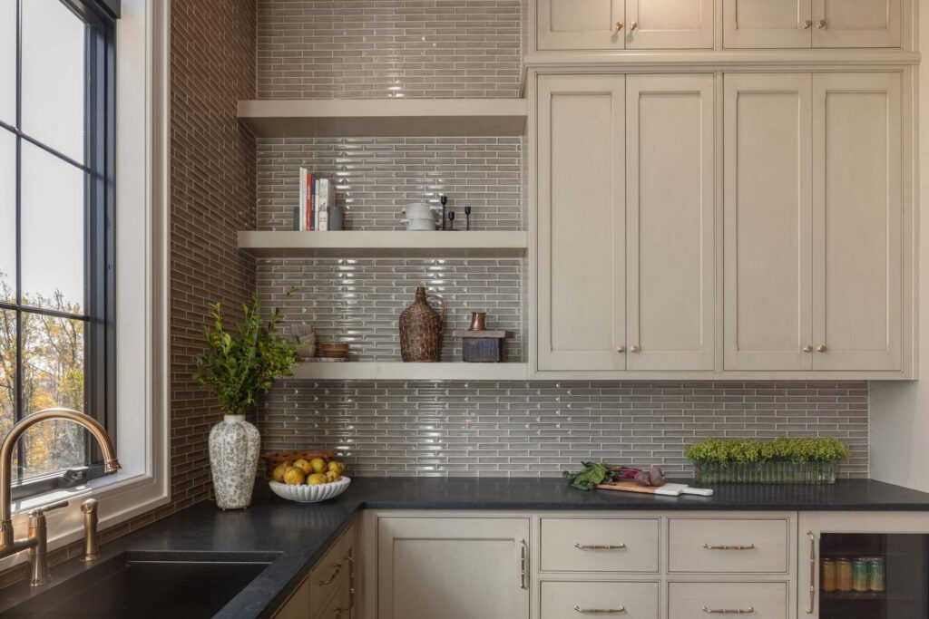 Painted inset butler's kitchen in Emmaus with open shelves, paneled beverage center, and dark countertop.