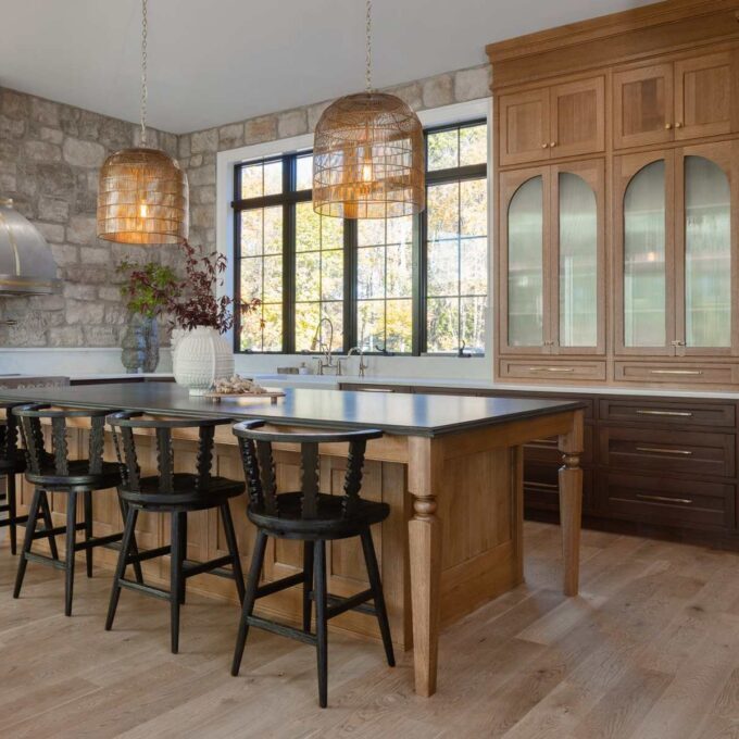 Emmaus kitchen with walnut base cabinets, quarter-sawn white oak island, arched glass doors, and integrated wall ovens.