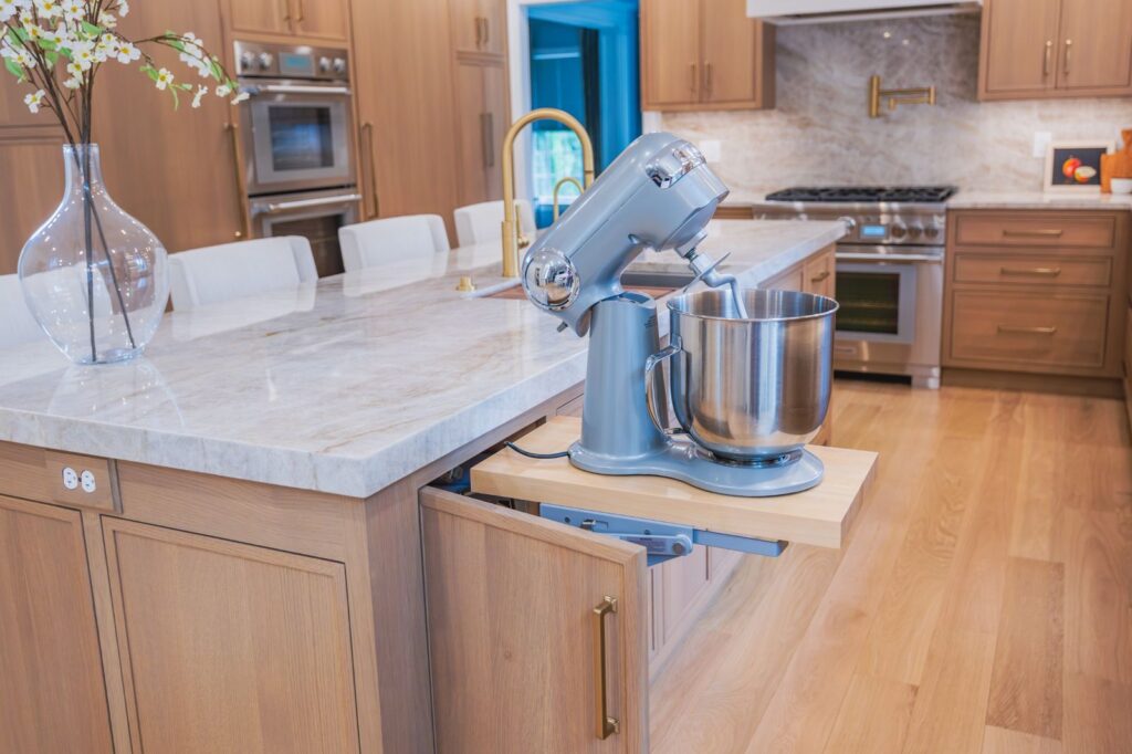 Custom kitchen island in Allentown, PA with a concealed mixer lift that raises a stand mixer to countertop height.