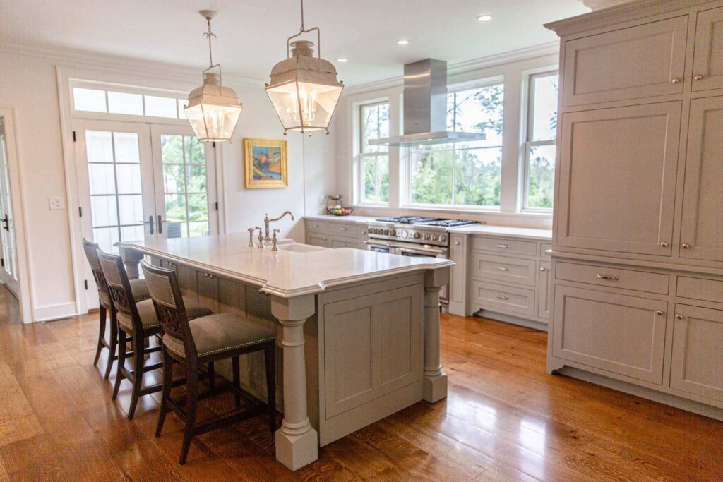 Traditional kitchen in Coopersburg, PA with painted cabinetry, a center island, tall cabinetry, and detailed crown molding and millwork.