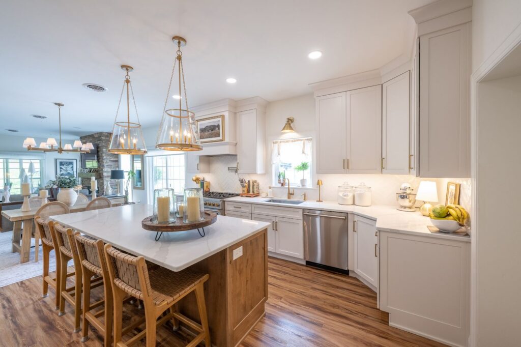 Open-concept kitchen in Hellertown, PA with a large wood island, seating for four, storage drawers, and white perimeter cabinetry.