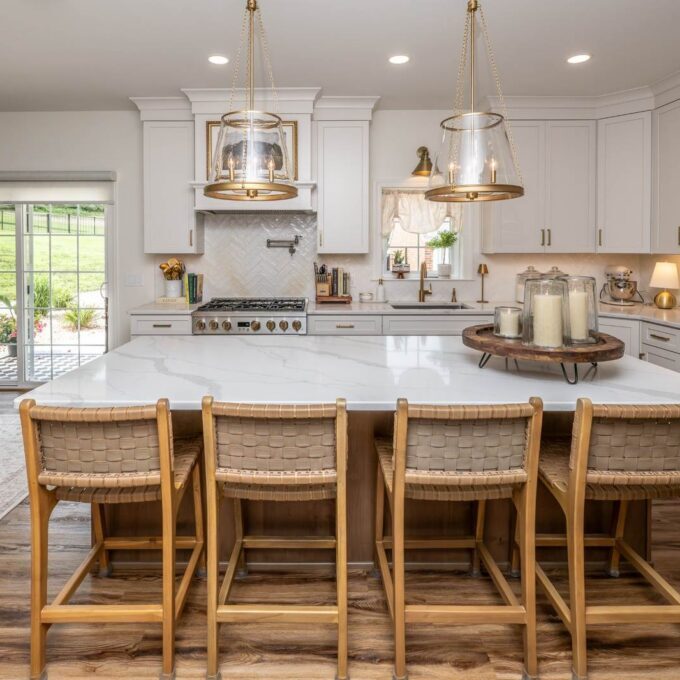 White kitchen in Hellertown, PA with a large natural wood island, seating for four, and pendant lighting.
