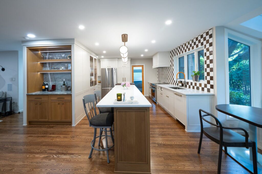 Allentown kitchen with a rift cut white oak island and dry bar, taupe inset cabinets, and a checkered backsplash.