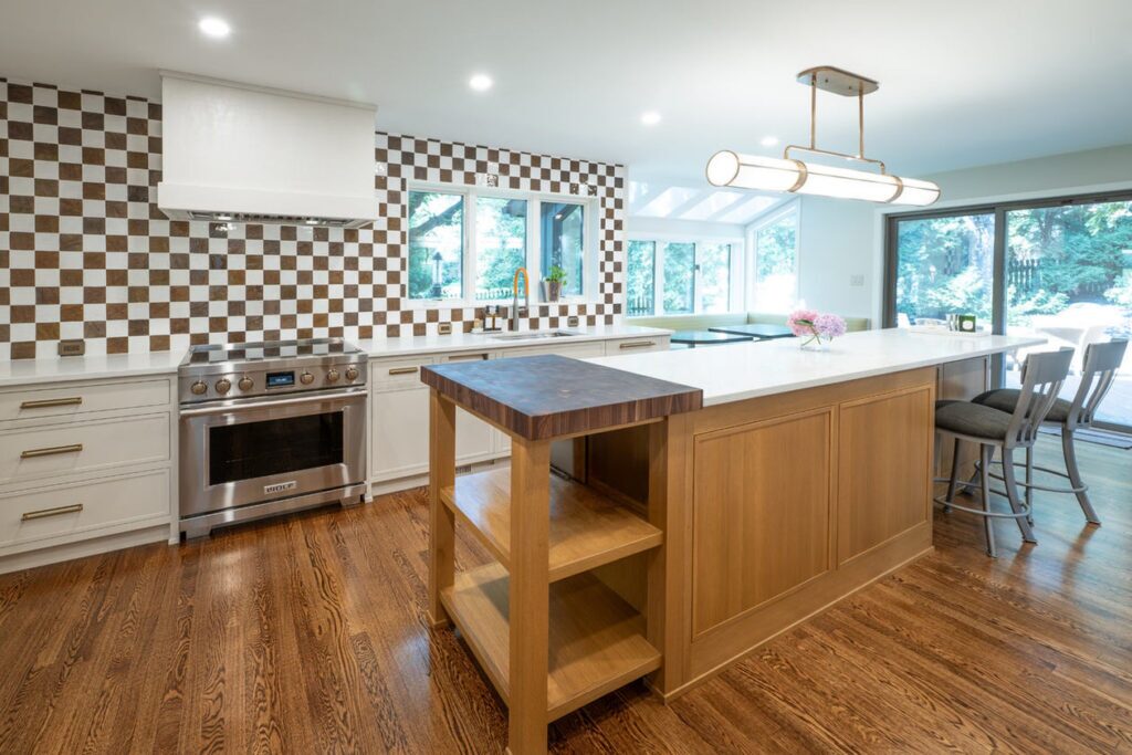 Rift cut white oak kitchen island end with a wood-topped extension and open shelving beside the range run.