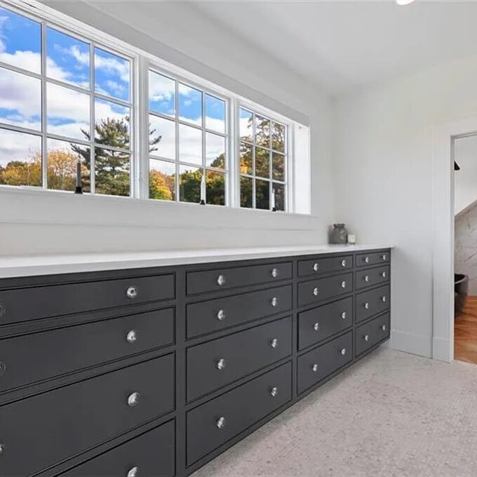 Black built-in drawers in a closet by Laslo Custom Kicthens.