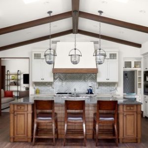 a laslo custom kitchen with wood beams and large white statemend range hood for a kitchen remodel