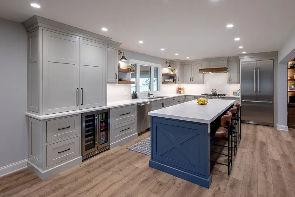 Stunning custom kitchen that showcases a stunning blue painted island and gray painted cabinets.