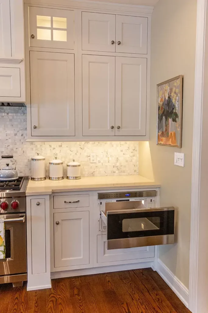 Custom pullout microwave drawer in kitchen and custom lighting under the cabinet.