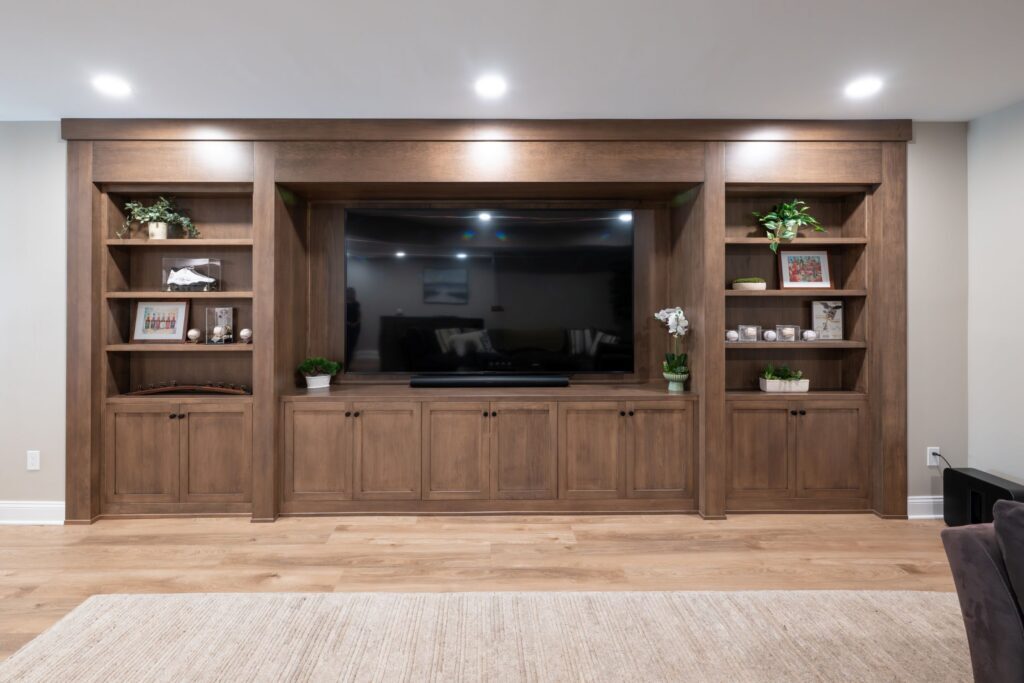 A view of the completed custom remodel in Center Valley, PA featuring a closed hard maple bookcase with hidden door and custom millwork.